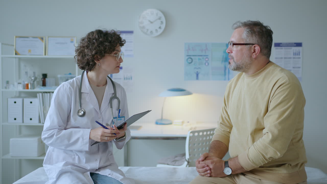 Young Female Doctor Consulting Patient after Health Check-Up in Clinic
