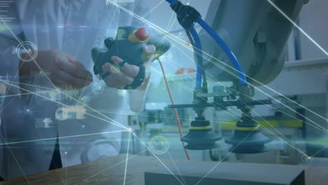 animation of network of connections over hands of caucasian man working in computer laboratory