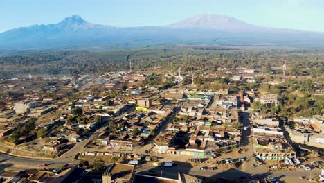 sunrise- kenya landscape with a village, kilimanjaro and amboseli national park - tracking, drone aerial view