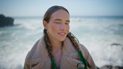 сomfortable woman relaxing ocean coast closeup. happy stylish model close eyes