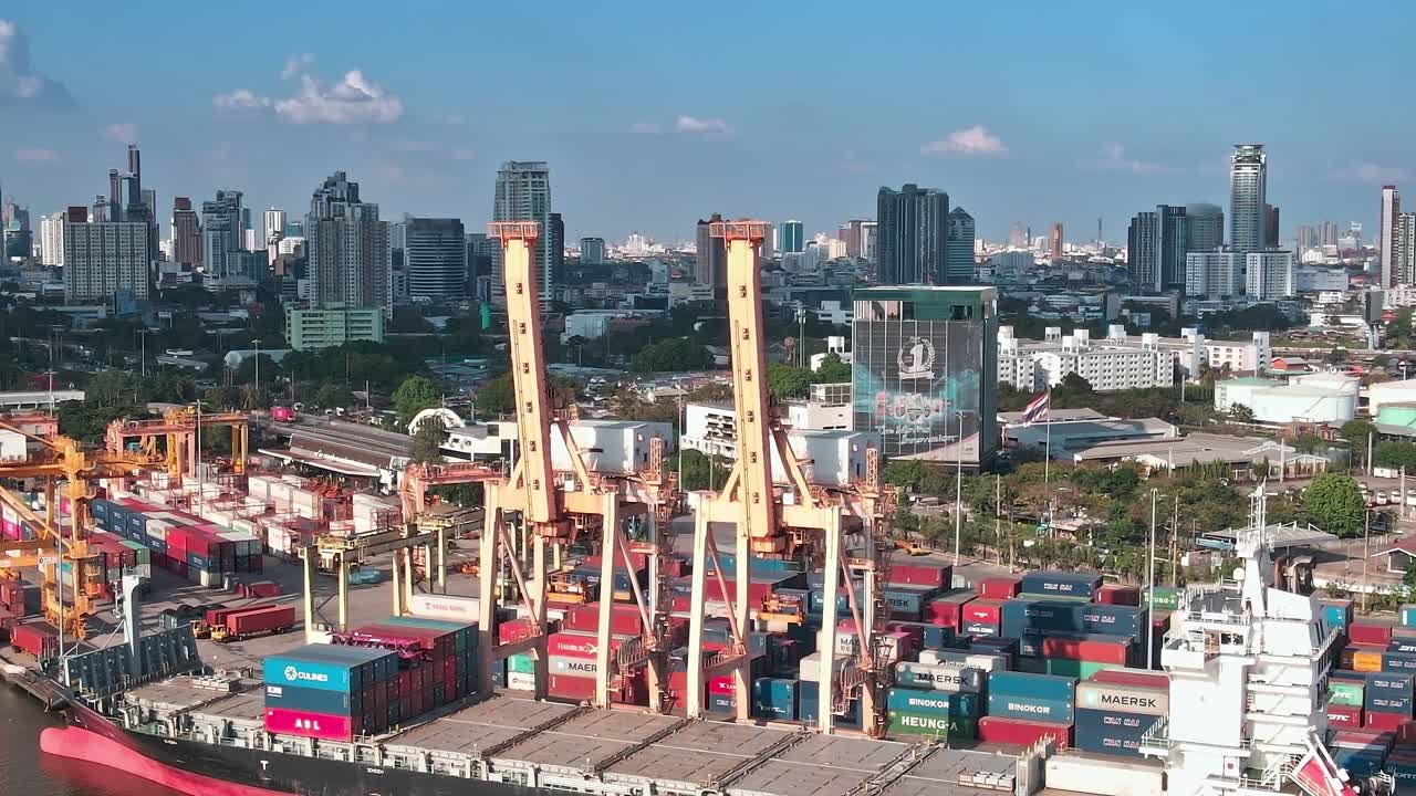 Aerial view of cargo ships and cityscape in Bangkok during the day