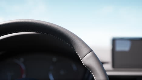 close-up of a car's steering wheel and dashboard.