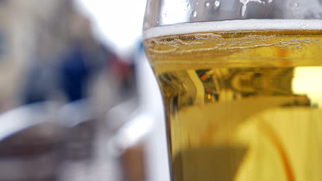 Glass-with-light-beer-in-outdoor-cafe