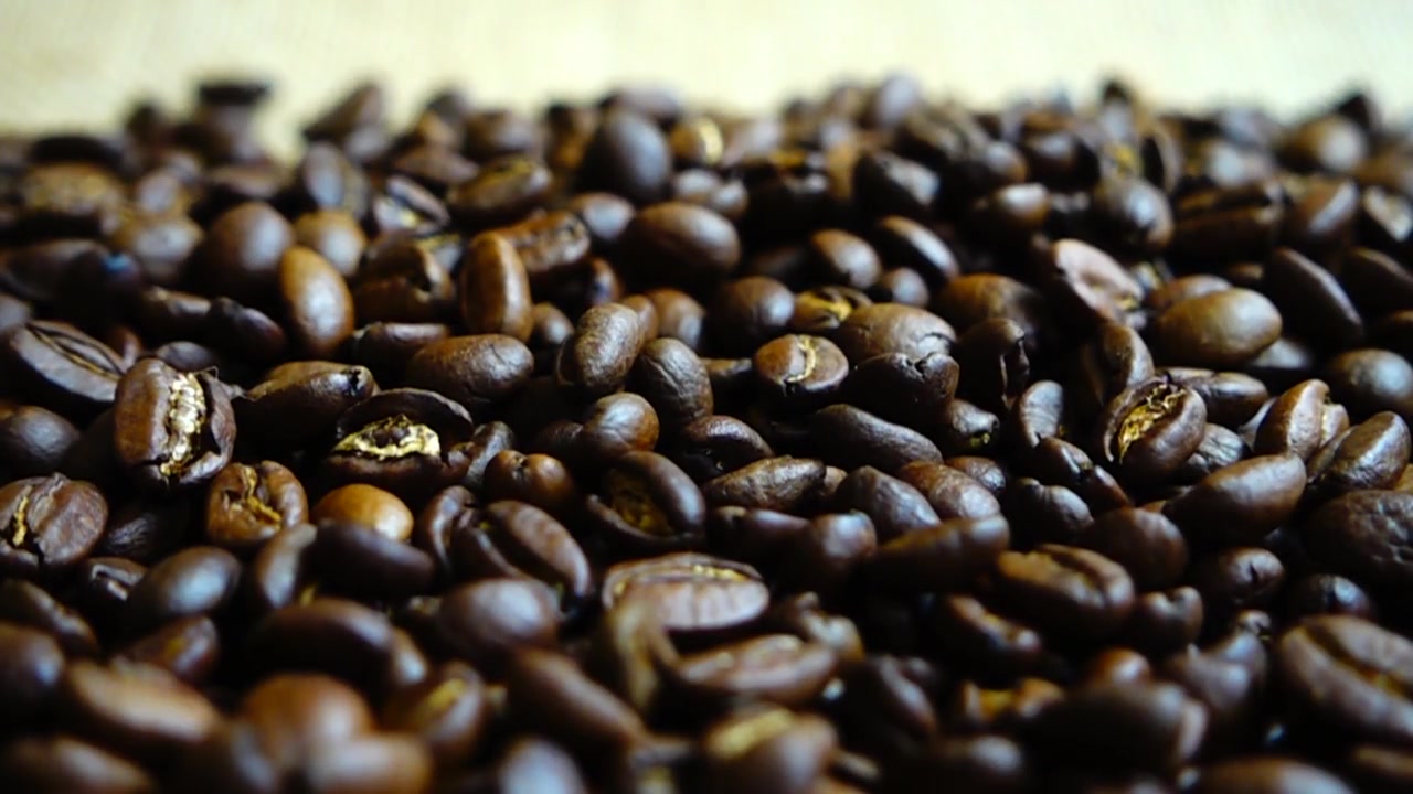 Chicchi di caffè che cadono sul sacco. Al rallentatore.