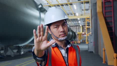 engineer gesturing stop in industrial facility