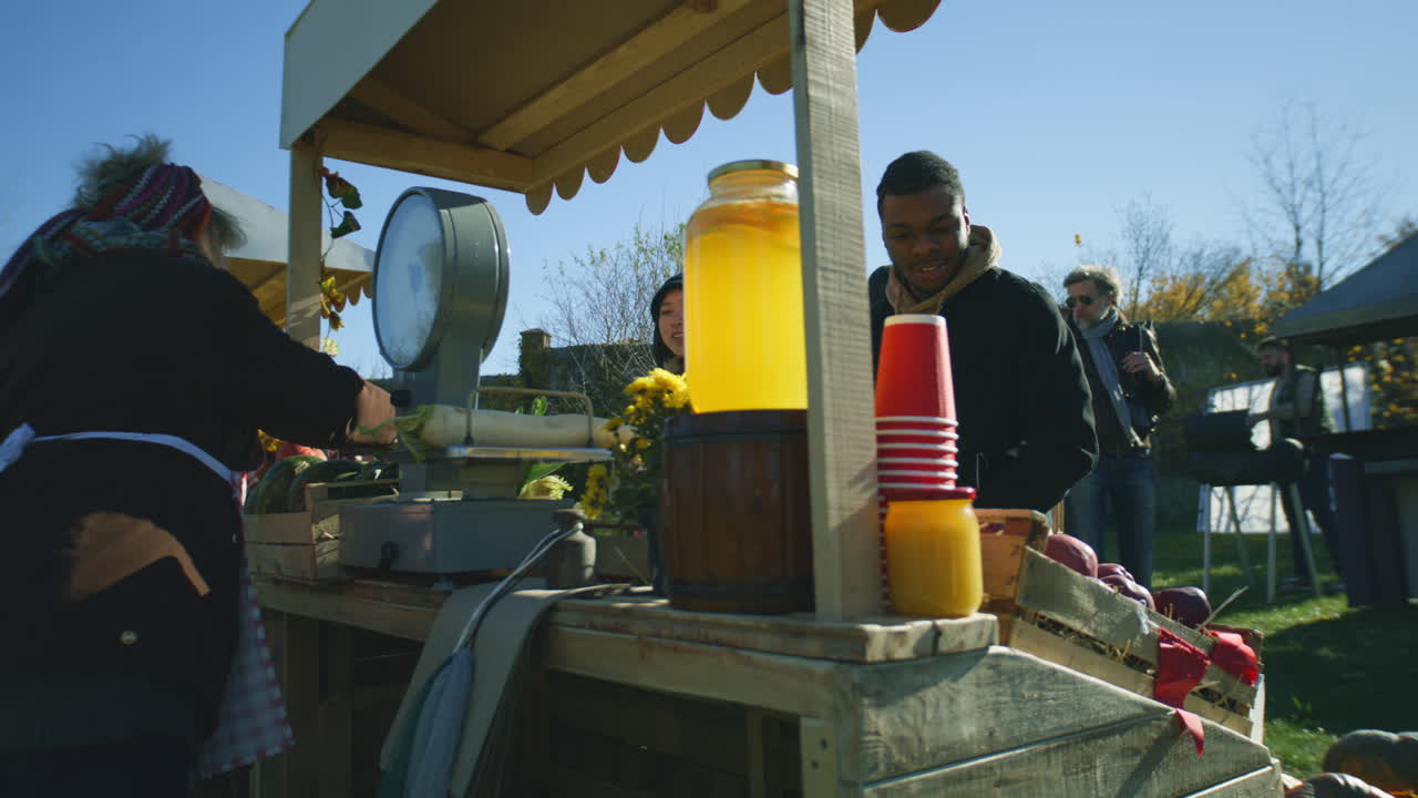 Diverse Couple at the Stall Choosing Products Diverse Couple at the Stall Choosing Fruits and Vegetables People Walking and Shopping on Background Local Farmers Market or Fair Outdoors Vegetarian and Organic Food Agriculture