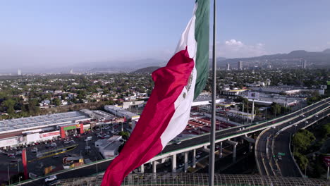 upwards drone shot of mexico national flag during windy day