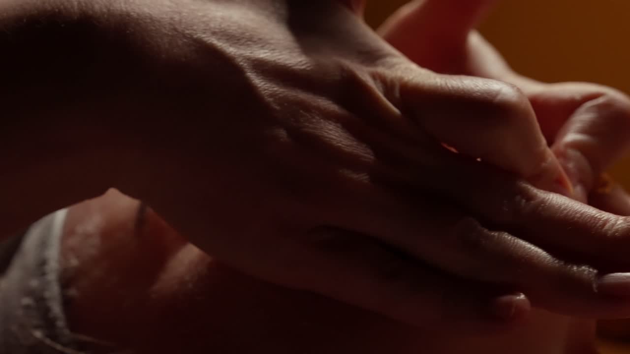 Close-up of Hands Giving a Relaxing Facial Massage