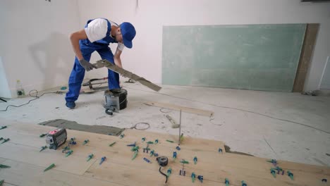 construction, renovation, repair apartment. installing ceramic floor tiles - measuring and cutting the pieces. cuts tile. tile cutting