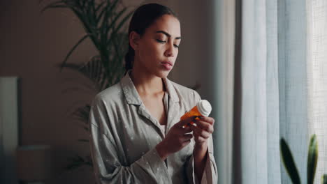 woman reading the label of her medicine bottle