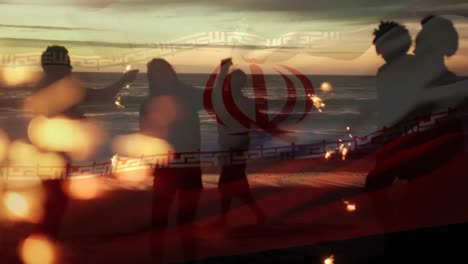 animation of waving flag of iran over group of friends having fun on the beach
