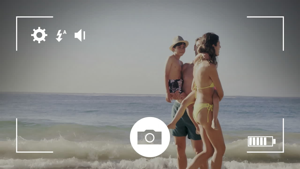 Animation of camera screen over caucasian family walking at seaside