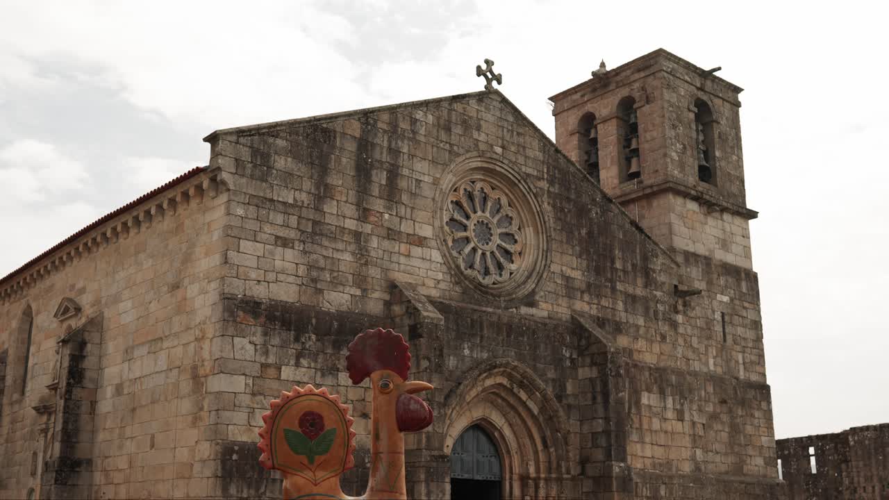 Historic Barcelos Church with the iconic Rooster of Barcelos in the foreground