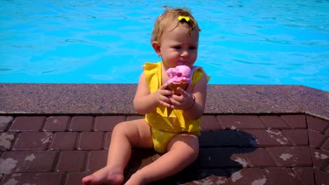 the child eats ice cream near the pool. selective focus. kid.