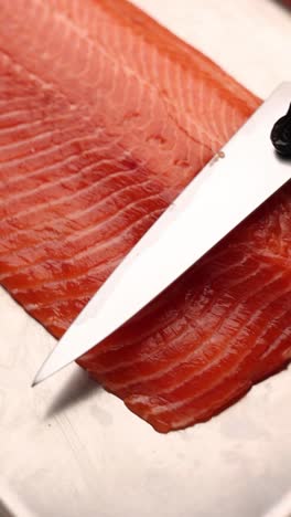 slicing raw salmon