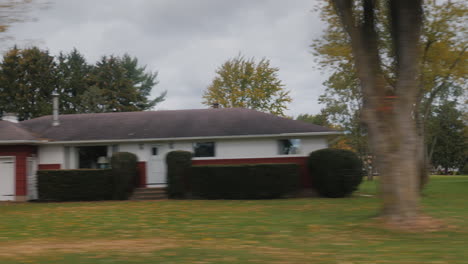 View from the window of a car that drives through a typical American suburb in the state of New York