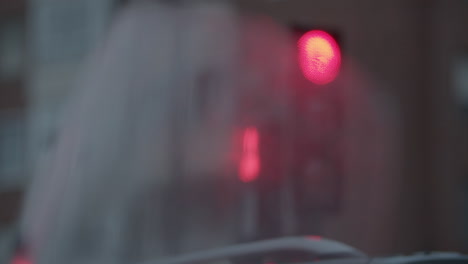 looking at traffic lights through wet motorcycle windscreen