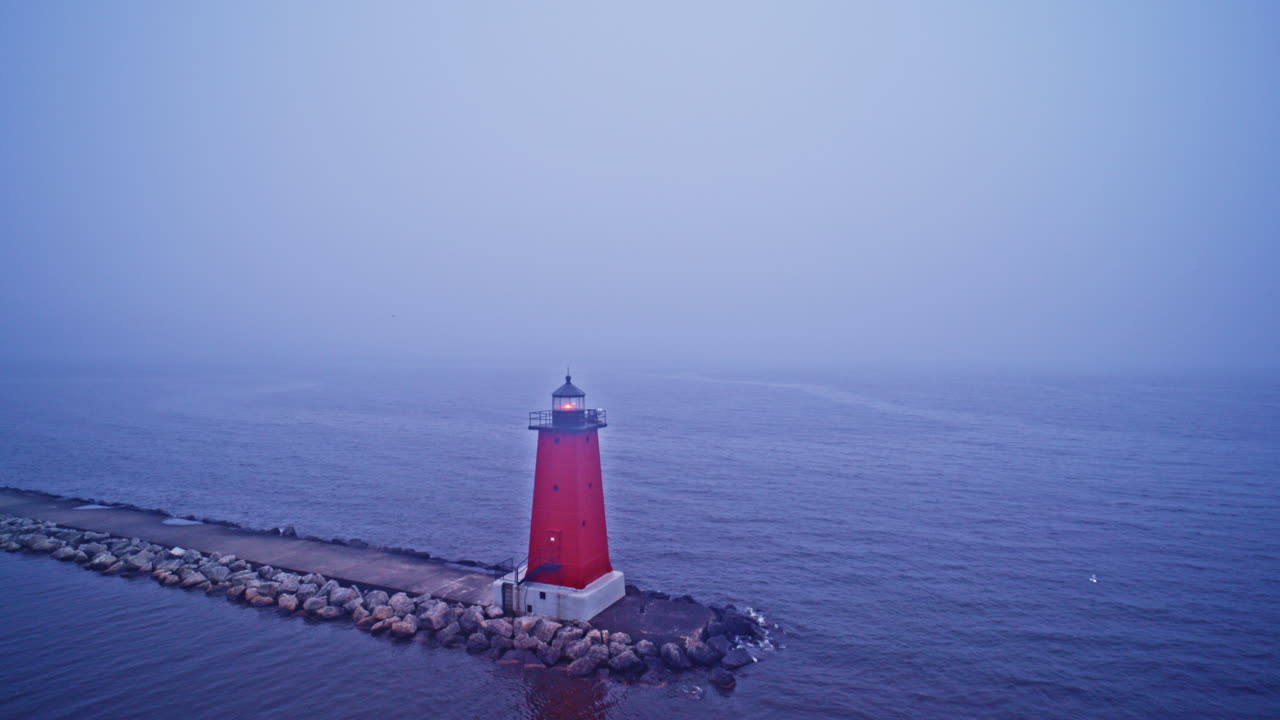 Red Lighthouse in Foggy Lake at Dusk