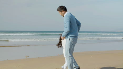 japanese man and his cute little daughter having fun at seashore