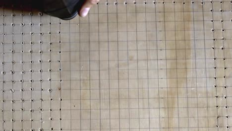 drilling a pattern of holes using a power tool and guided by grid lines