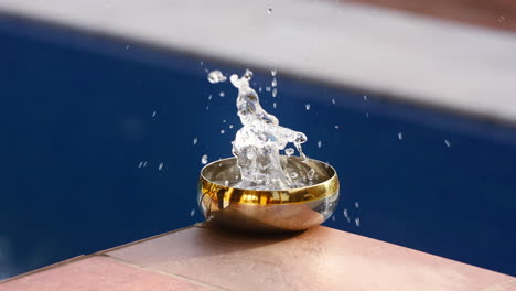 Slow-motion-of-water-drops-into-the-bowl-and-splashes