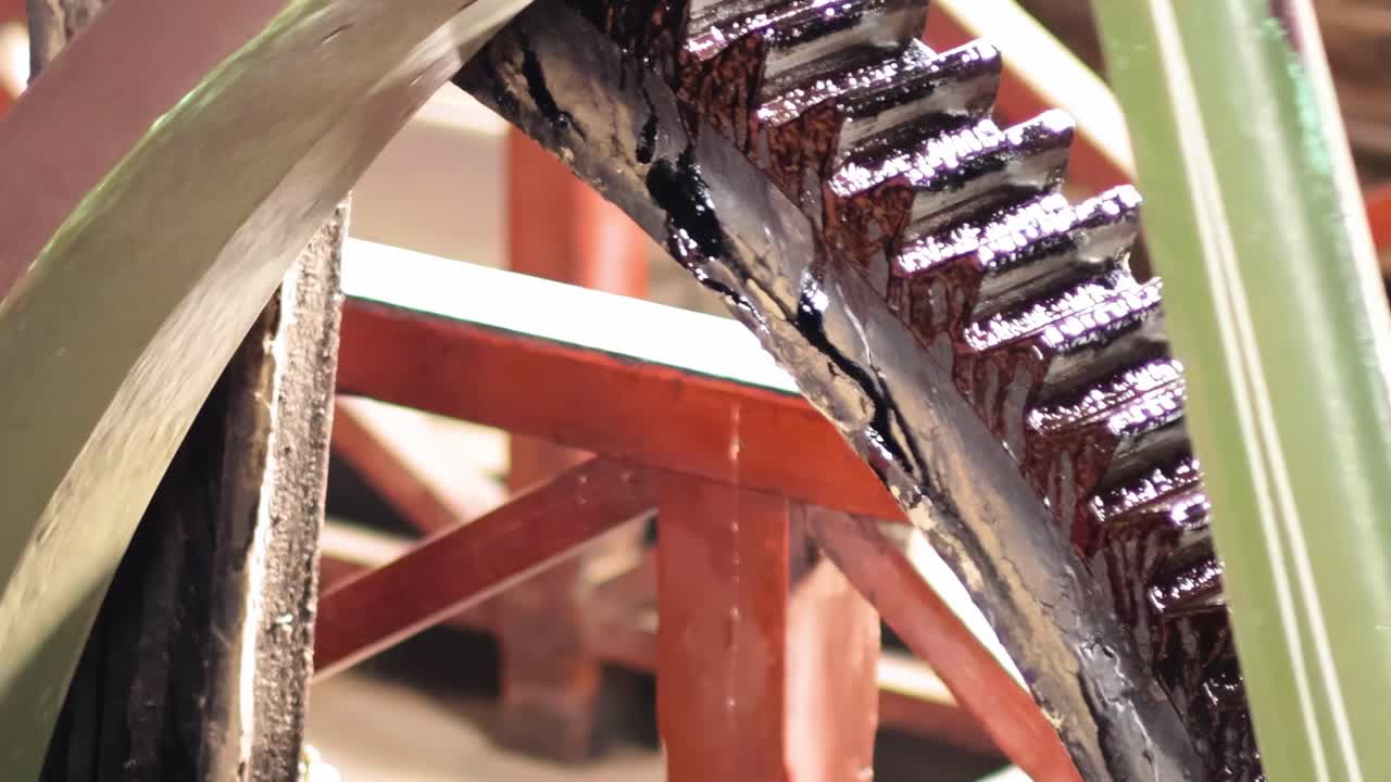 Detailed view of a green gear with visible teeth and structural framework.