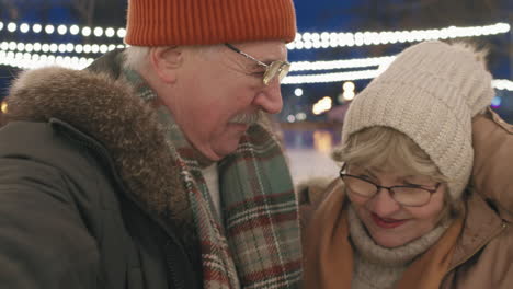 elderly couple at an ice skating rink