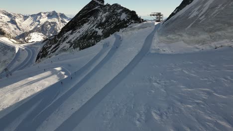 aerial-view-of-ski-slopes-on-top-of-the-swiss-mountains,-winter-landscape