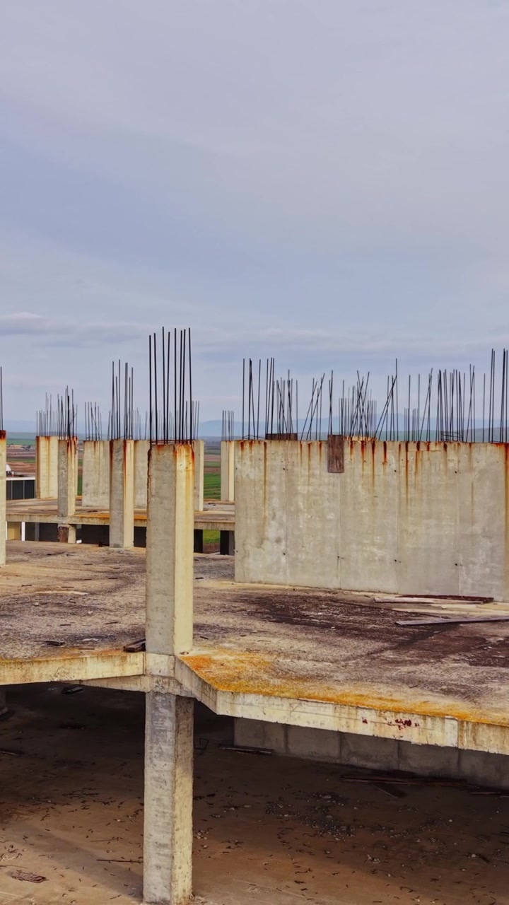 Construction site view of a partially built structure in an open landscape