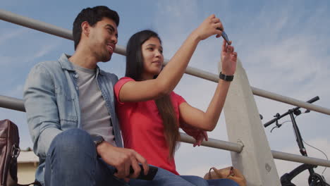 young couple taking selfies