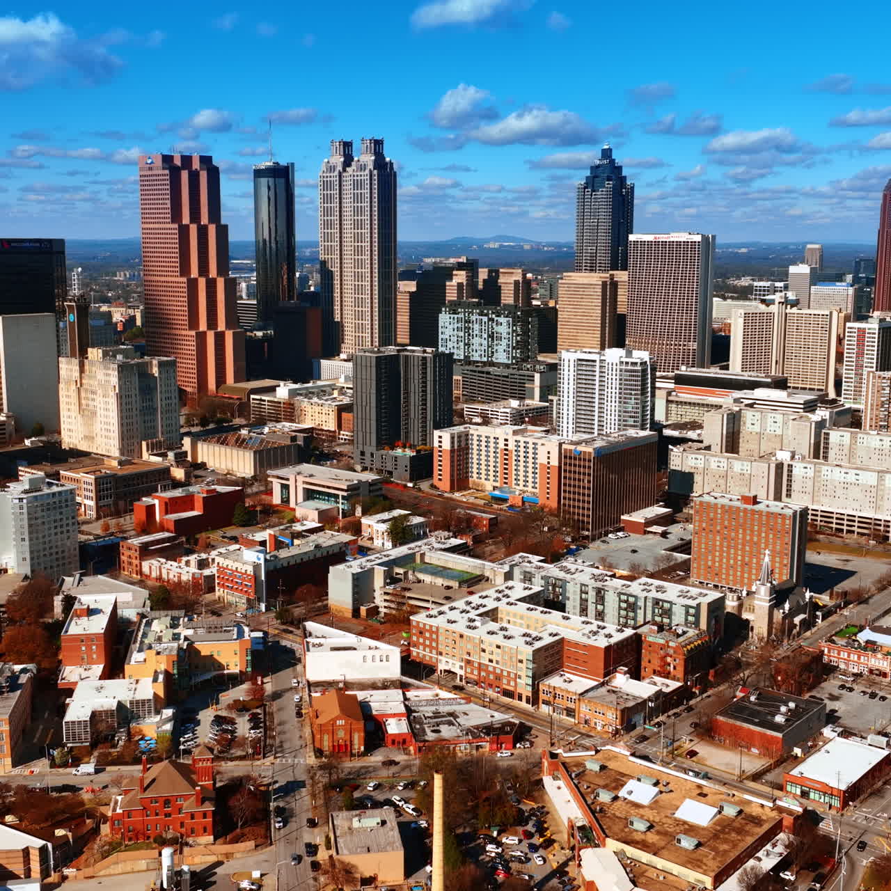 Flight above the low-rise and high-rise architecture of American city. Approaching skyscrapers in Atlanta downtown.