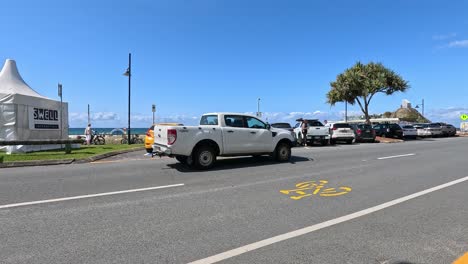 cars driving along the beachside road