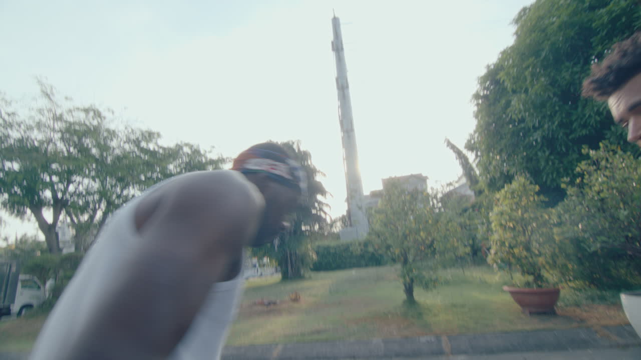 Young Men Playing Basketball on Outdoor Playground on Summer Day