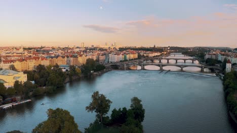 Drone-aerial-hyper-lapse-pullback-over-European-city-river-arch-bridge-crossing