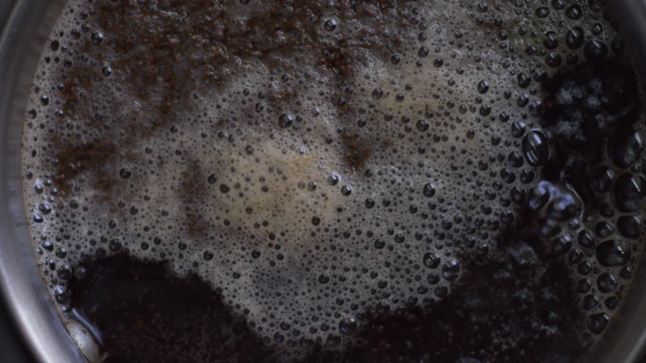 A detailed closeup top view of bubbling tea with foam