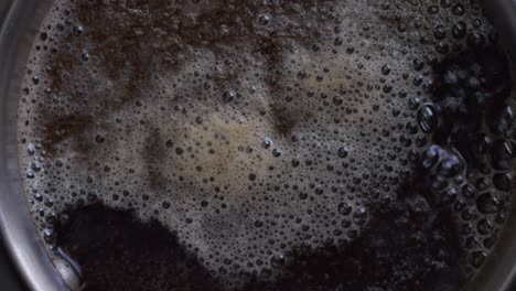 a detailed closeup top view of bubbling tea with foam