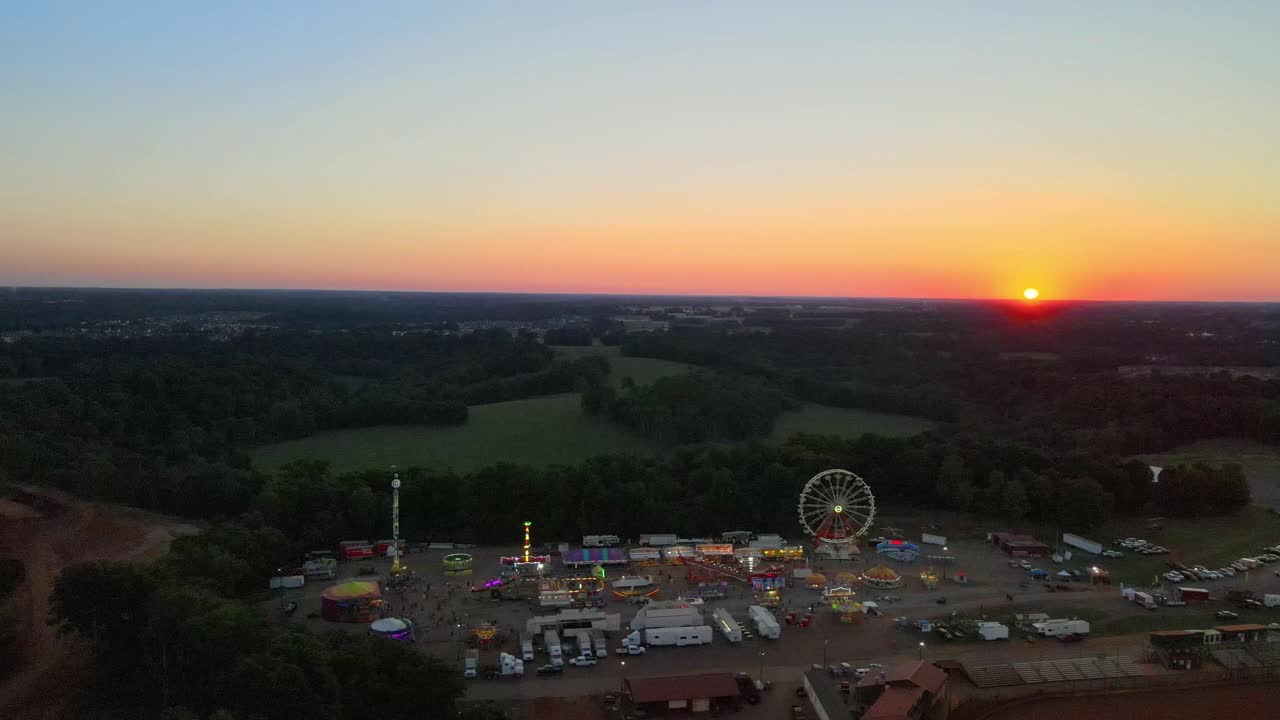 Aerial view of s small town carnival during a beautiful sunset