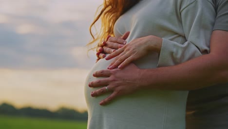couple supporting a pregnant woman
