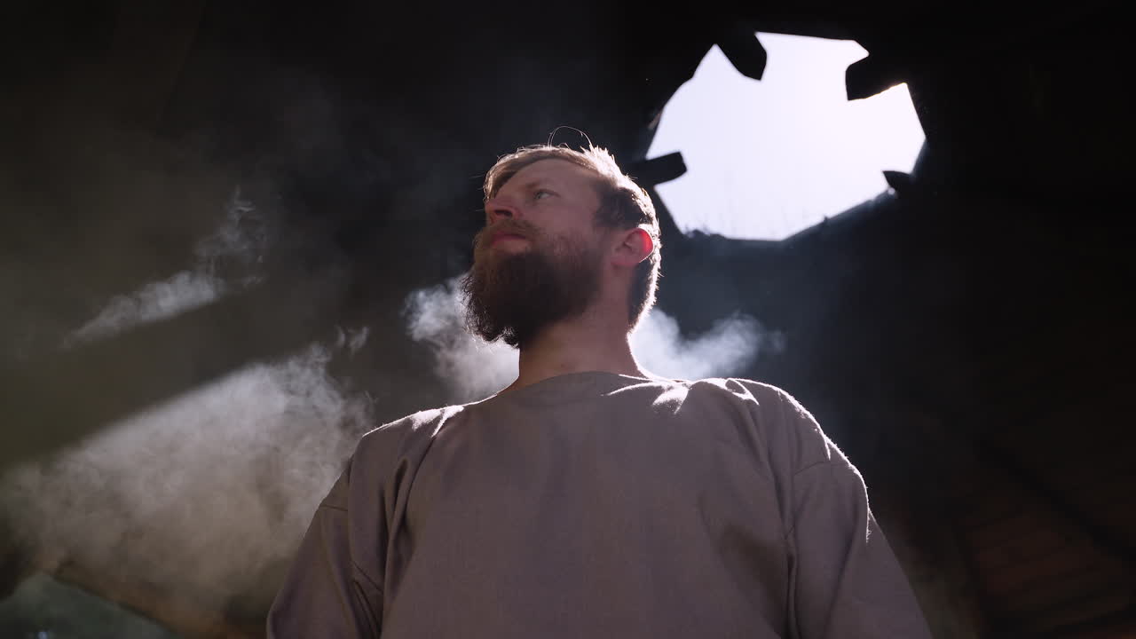 Man Drinking Hot Beverage in a Rustic Setting