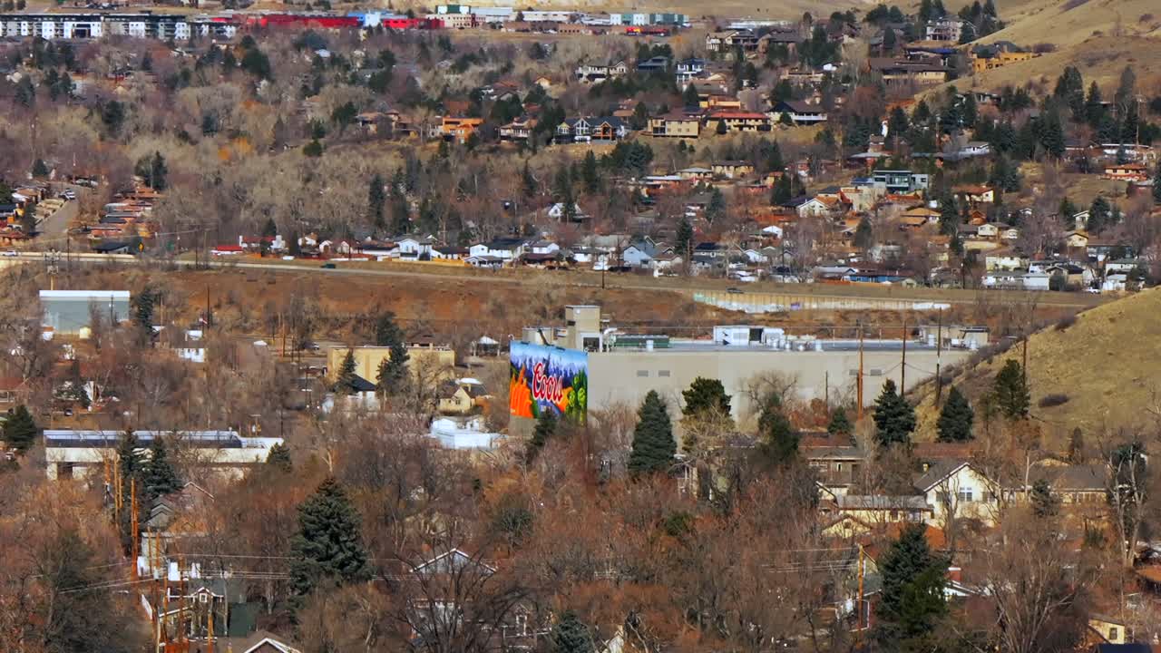 Beautiful crisp cold winter day sunny clouds downtown historic Golden Colorado aerial drone Coors Beer Factory North Table Mountain Flat Irons Boulder highway 93 Golden Gate Canyon upwards jib motion