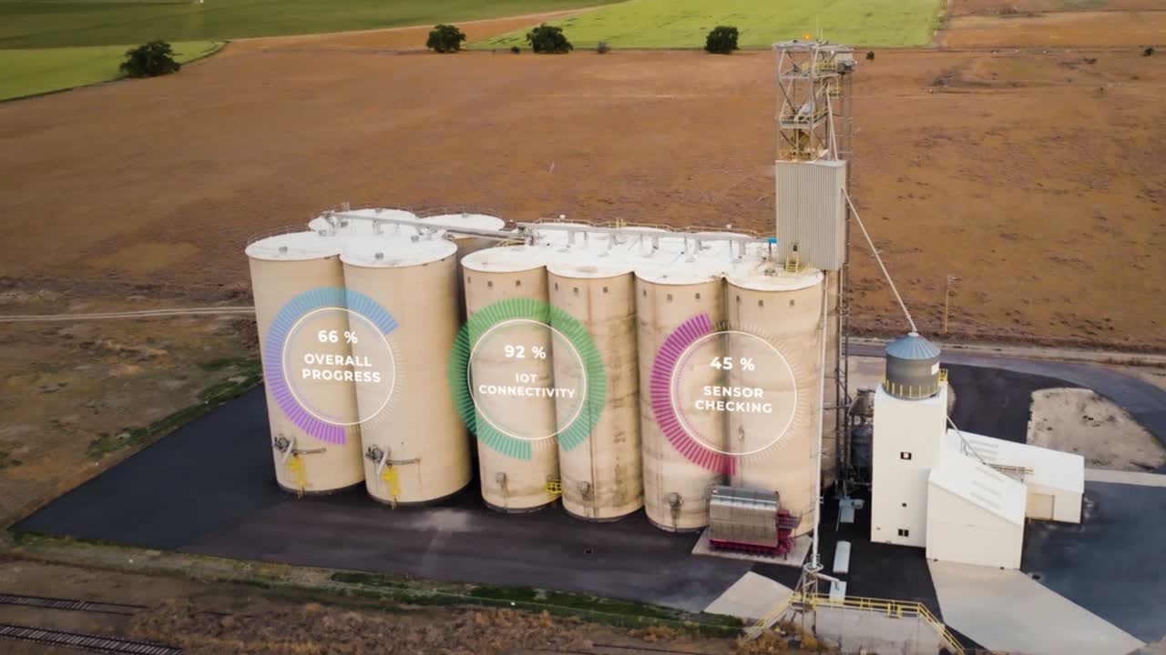 Grain silo storage facility with IoT smart sensor monitoring for optimized crop growth - aerial view concept animation of production