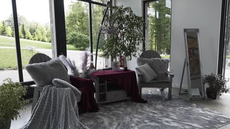 Cozy-photoshoot-corner-interior-with-plants-near-scenic-garden-window-view