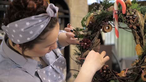 florist at work. how to make christmas wreath with floral arrangement. step by step, tutorial