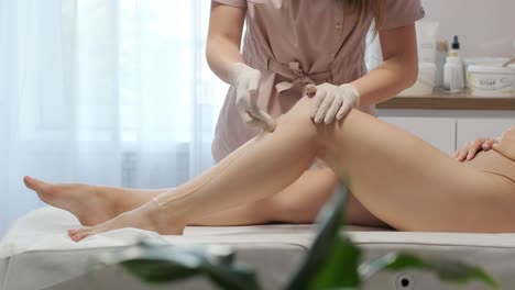 laser epilation - hair removal procedure. flash of diode laser hair removal, beautician removes hair on beautiful female legs, hair removal for smooth skin, laser procedure at beauty studio or clinic, body care epilation treatment.