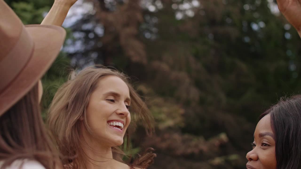 Tři ženy tančící na hudebním festivalu