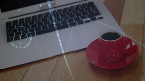 silver laptop keyboard and trackpad with red coffee cup resting on wooden table in flat design