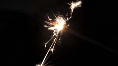 a close up shot of a sparkler in the dark filmed at 60fps