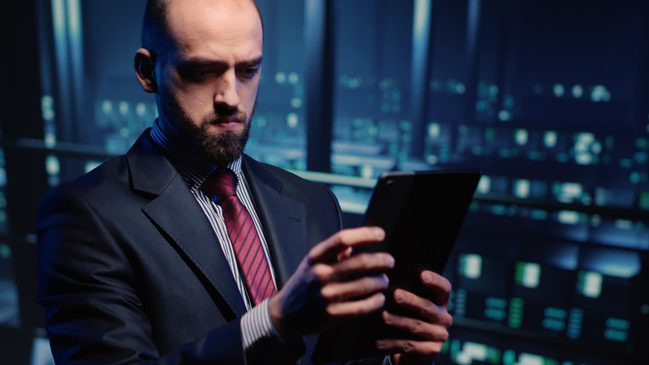 Male database admin checking hosting server on tablet