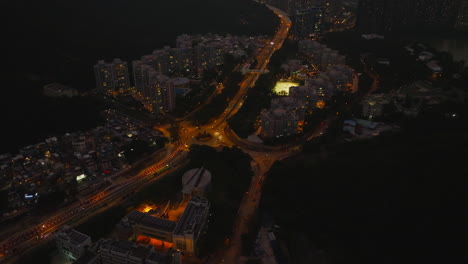 Stunning-static-aerial-view-of-a-city-after-sunset-and-lit-up-lights