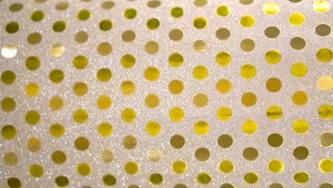 punto dorado en papel plateado brillante giratorio, punto
